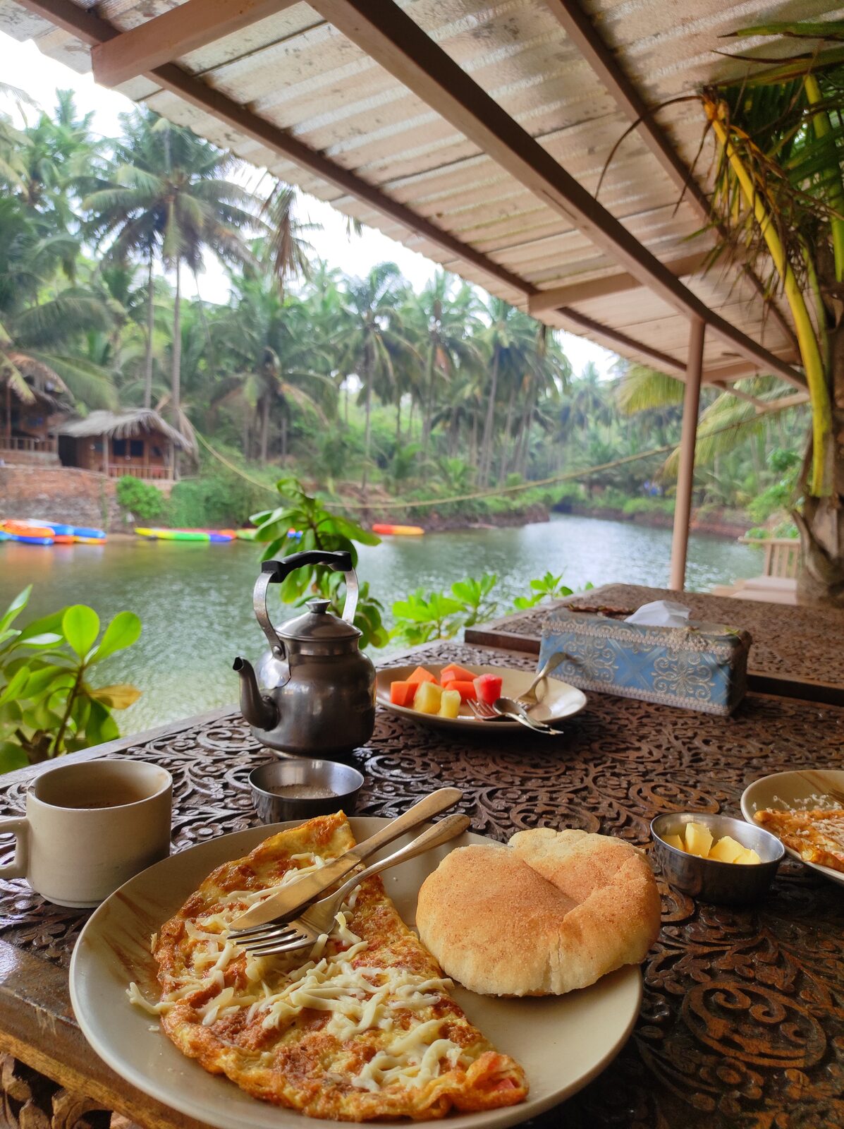 Breakfast table overlooking the lagoon and its kayaks